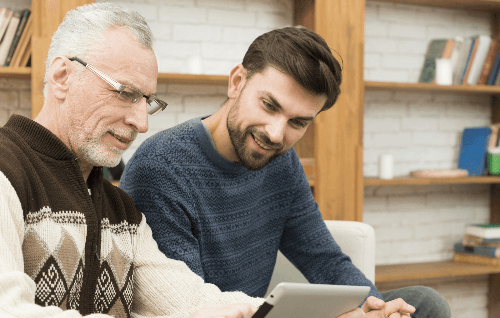 Senior man using laptop with coffee cup